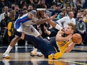 Indiana Pacers forward Domantas Sabonis dives for a loose ball while Detroit Pistons forward Saddiq Bey defends in the first half at Gainbridge Fieldhouse.