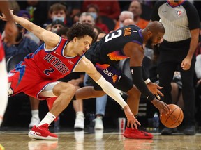 Phoenix Suns guard Chris Paul steals the ball from Detroit Pistons guard Cade Cunningham in the second half at Footprint Center.