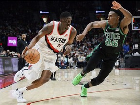 Portland Trail Blazers forward Tony Snell drives to the basket against Boston Celtics forward Aaron Nesmith during the second half at Moda Center. The Celtics won 145-117.