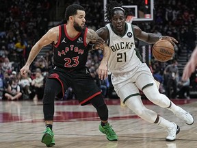 Milwaukee Bucks guard Jrue Holiday drives to the net against Toronto Raptors guard Fred VanVleet during the second half at Scotiabank Arena.