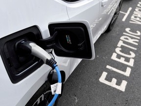 FILE PHOTO: An electric car is charged at a roadside EV charge point, London, October 19, 2021.