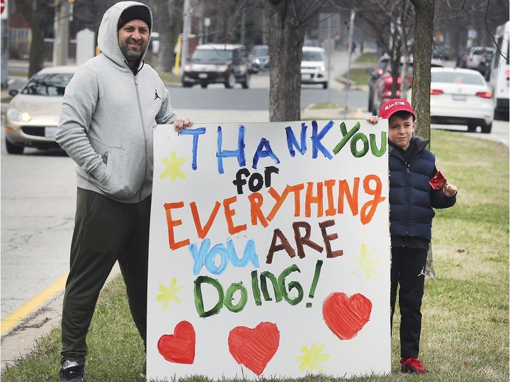  Front-line health care workers have faced harassment, threats and worse. But there have also been plenty of open displays of support for their pandemic work, including by this father and son shown outside Windsor Regional Hospital’s Met campus on March 27, 2020.