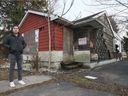 City Coun. Fabio Costante is shown next to a boarded up home on Edison Street on Tuesday, December 14, 2021.