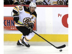 Brad Marchand of the Boston Bruins skates with the puck during the first period of action as the Calgary Flames host the Boston Bruins at the Saddledome. Saturday, December 11, 2021.