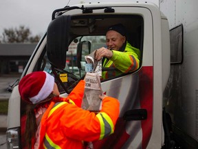 Windsor Goodfellows volunteer Tracey Rogers collects a donation from a truck driver on Nov. 25, 2021.