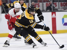 Boston Bruins right wing Craig Smith controls the puck away from Detroit Red Wings right wing Filip Zadina during the second period at TD Garden.