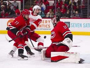 Carolina Hurricanes goaltender Frederik Andersen and  defenseman Tony DeAngelo stop the shot attempt of Detroit Red Wings center Dylan Larkin during the second period at PNC Arena.