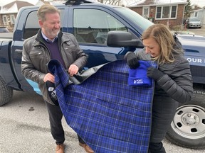Steve Salmons, president and CEO of Windsor Port Authority, and Joyce Zuk, executive director of Family Services Windsor-Essex, check out one of the new waterproof mats that will be distribute to Windsor's homeless population.  Port Windsor donated 100 mats, 100 toques and $2,021 on Wednesday to Family Services Windsor-Essex.  Trevor Wilhelm / Windsor Star