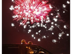 A couple of youngsters watch the New Year's Eve fireworks show on Friday, Dec. 31, 2021, from the sunroof of a pickup at the Vollmer Complex in LaSalle.