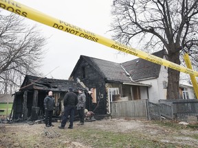 Windsor police and fire service investigators are shown on the scene of a house fire in the 200 block of Louis Avenue on Tuesday, December 7, 2021. According to an official the home was vacant and no injuries were reported.
