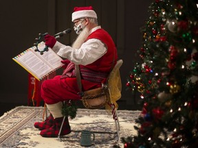 Santa reads some Christmas stories to children and their parents during the Miracle in Sandwich at Mackenzie Hall, on Saturday, Dec. 4, 2021.