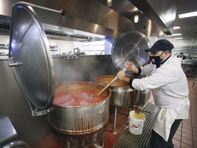 Ciociaro Club cook Sal Papasodaro makes a huge pot of meat sauce on Wednesday, December 29, 2021. There will be no New Year's Eve parties at the banquet hall but they are offering an elaborate festival meal pick-up service.