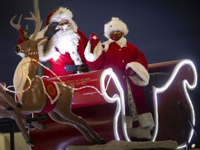 Ho! Ho! Ho! Santa Claus and Mrs. Claus wave at cars passing by during last year's Windsor Santa Claus Parade, presented in a drive-thru format at St. Clair College on Dec. 6, 2020.