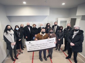 The Solcz Family Foundation donated another $200,000 to complete the construction for the Family Respite Services Respite Home on December 8, 2021. Isaac Hu, 13, and his mother Cathy Sun are shown with the ceremonial cheque with members of the Solcz family and representatives from the Family Respite Services organization. The family has donated a total or $725,000 to the project.