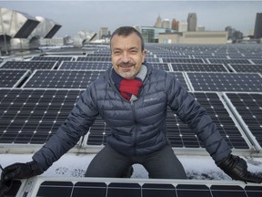 Sokol Aliko, manager of Energy Initiatives at the City of Windsor, is pictured among rows of solar panels on the roof of the Windsor International Aquatic and Training Centre, on Wednesday, Dec. 8, 2021.