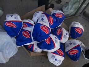 Frozen turkeys are handed out for the Mikhail Holdings Holiday Turkey Giveaway, on Friday, Dec. 17, 2021.