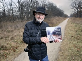 Marty Gervais, Windsor's Poet Laureate Emeritus is shown at the Ojibway Prairie Complex on Thursday, December 9, 2021, with a book he collaborated on entitled "Walk in the Woods: Portrait of the Ojibway Prairie Complex.