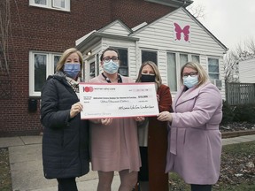 The 100 Women Who Care Windsor/Essex organization presented a cheque to the Welcome Centre Shelter for Women & Families on Tuesday, December 29, 2021. Lady Laforet, Executive Director of the Welcome Centre Shelter for Women and Families, second from left, poses with 100 WWCWE members, Maureen Lucas, left, Liz Farano and Chantelle Meadows.