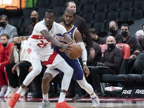 Raptors forward Chris Boucher (25) controls the ball as Phoenix Suns guard Chris Paul (3) defends. Boucher has big a big boost off the bench for the Raptors.