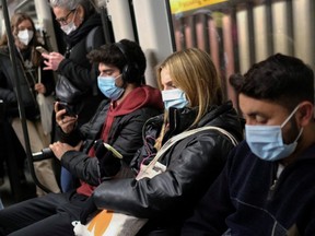Commuters travel on a subway train, amid the outbreak of COVID-19 and after Omicron has become the dominant virus variant in Europe, in Barcelona, Spain, Wednesday, Jan. 12, 2022.