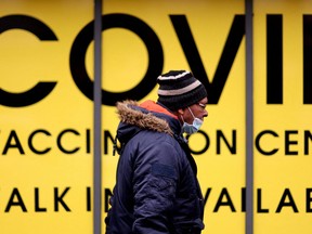 A man walks past the Soho Pharmacy, Handsworth, Birmingham, Britain, Jan. 10, 2022.