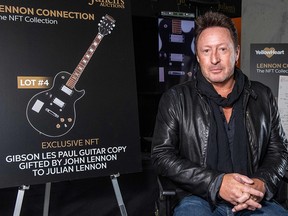 Artist/musician Julian Lennon poses in front of the NFT part of an auction featuring cherished Beatles and John Lennon memorabilia from his private collection, at Julien's Auctions, in Beverly Hills January 25, 2022.