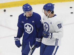 Mitch Marner (left) chatting with John Tavares at a Leafs practice, will be in the lineup against the Blues tonight in St. Louis, along with Pierre Engvall.
