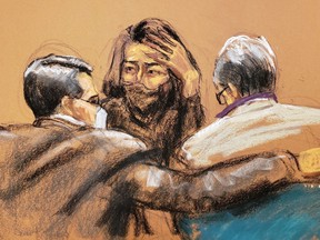 Ghislaine Maxwell speaks with her attorneys as she decides whether or not to testify during the trial of Maxwell, the Jeffrey Epstein associate accused of sex trafficking, in a courtroom sketch in New York City, Dec. 17, 2021.