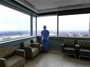 A registered nurse looks out the window in the ICU at the Humber River Hospital in Toronto on April 13, 2021.
