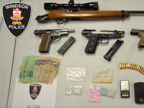 Windsor police have released this photo of the guns, ammunition, cash and drugs found during a raid of Thursday of a home in the 1400 block of Pillette Road.