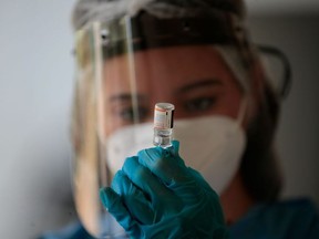 A nurse gets ready to inoculate a child with the first one dose of the Pfizer-BioNTech vaccine against the novel coronavirus disease, COVID-19, at the Children's Hospital in Panama City on January 7, 2022.