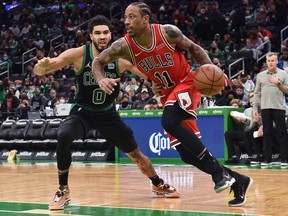 Chicago Bulls forward DeMar DeRozan controls the ball while Boston Celtics forward Jayson Tatum defends during the second half at TD Garden.