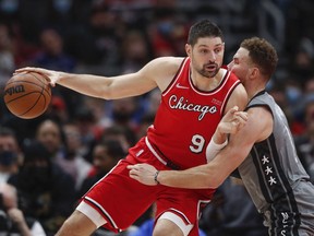 Chicago Bulls center Nikola Vucevic dribbles the ball while defended by Brooklyn Nets forward Blake Griffin during the second half at United Center.