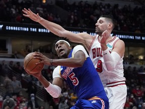 Chicago Bulls center Nikola Vucevic defends Golden State Warriors center Kevon Looney during the second half at United Center.