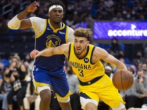 Indiana Pacers guard Chris Duarte drives around Golden State Warriors forward Kevon Looney during the second quarter at Chase Center.