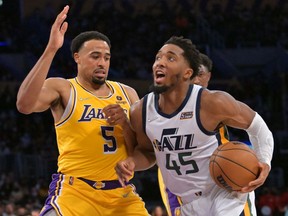 Los Angeles Lakers guard Talen Horton-Tucker defends Utah Jazz guard Donovan Mitchell in the second half at Crypto.com Arena.
