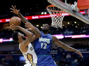 New Orleans Pelicans guard Nickeil Alexander-Walker is blocked by Minnesota Timberwolves forward Taurean Prince in the second half at the Smoothie King Center.