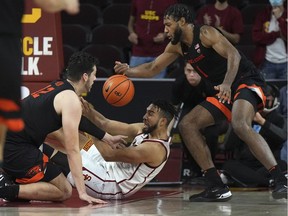 Southern California Trojans forward Isaiah Mobley (3) battles for the ball with Oregon State Beavers centre Roman Silva (12) and forward Maurice Calloo (10) in the second half at Galen Center in Los Angeles, Jan. 13, 2022. USC defeated OSU 81-71.