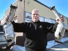Doug White, manager at Marcel's Collision in Windsor displays a couple of catalytic converters at the Windsor business on Wednesday, January 26, 2022.