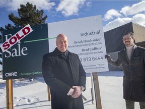 Brook Handysides, left, and Brad Collins, of CBRE, as pictured in front of a recently sold commercial property on Hawthorne Drive, on Tuesday, January 25, 2022.
