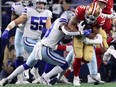 Dallas Cowboys free safety Damontae Kazee attempts to tackle San Francisco 49ers running back Elijah Mitchell during the second half of the NFC Wild Card playoff football game at AT&T Stadium.