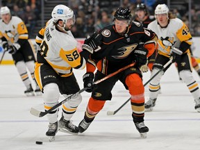 Anaheim Ducks left wing Rickard Rakell and Pittsburgh Penguins defenseman Kris Letang battle for the puck in the first half of the game at Honda Center.