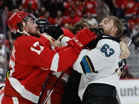 Detroit Red Wings defenseman Filip Hronek and San Jose Sharks left wing Jeffrey Viel shove each other during the third period at Little Caesars Arena.