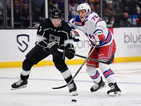 Los Angeles Kings defenseman Tobias Bjornfot steals the puck from New York Rangers center Jonny Brodzinski during the third period at Crypto.com Arena.