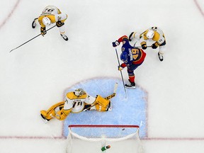 St. Louis Blues center Ivan Barbashev shoots and scores against Nashville Predators goaltender Juuse Saros during the first period at Enterprise Center.