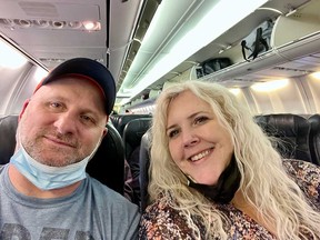 Tracy Kell (right) of Windsor with her husband Joel Morris (left) onboard a plane for their trip to Varadero, Cuba, on Dec. 30, 2021.