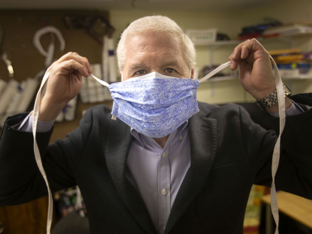  Ken Drouillard, professor at the Great Lakes Institute for Environmental Research, and who participated in a mask study to see what approach is comparable to an N95 mask, is pictured at his home on Monday, January 17, 2022. Here he holds a cloth mask that when tied tight over a surgical mask can be comparable to an N95 mask.