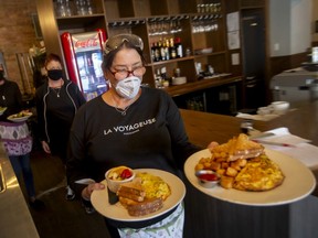 Lisa Cusmanic, waitress at Twisted Apron in Walkerville, places a food order on Tuesday, January 4, 2021.
