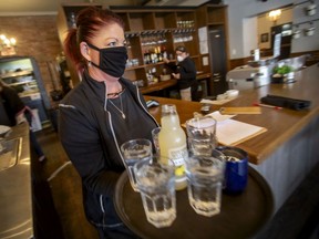 Kelly Heydon, a server at the Twisted Apron in Walkerville, carries out a drink order on Tuesday, January 4, 2021.
