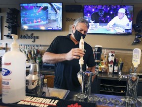 Rick Limoges of Sandy's Riverside Grill in Windsor pours a beer on Monday, January 3, 2022. He and his wife Sandy are preparing to shut down indoor dining service after new provincial restrictions were announced.